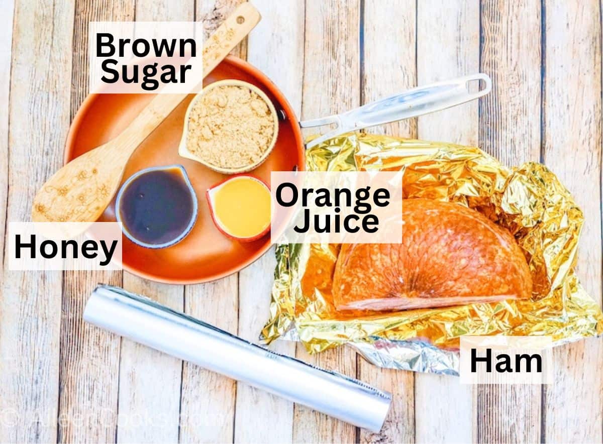 Ingredients for air fryer ham laid out on a wooden cutting board.