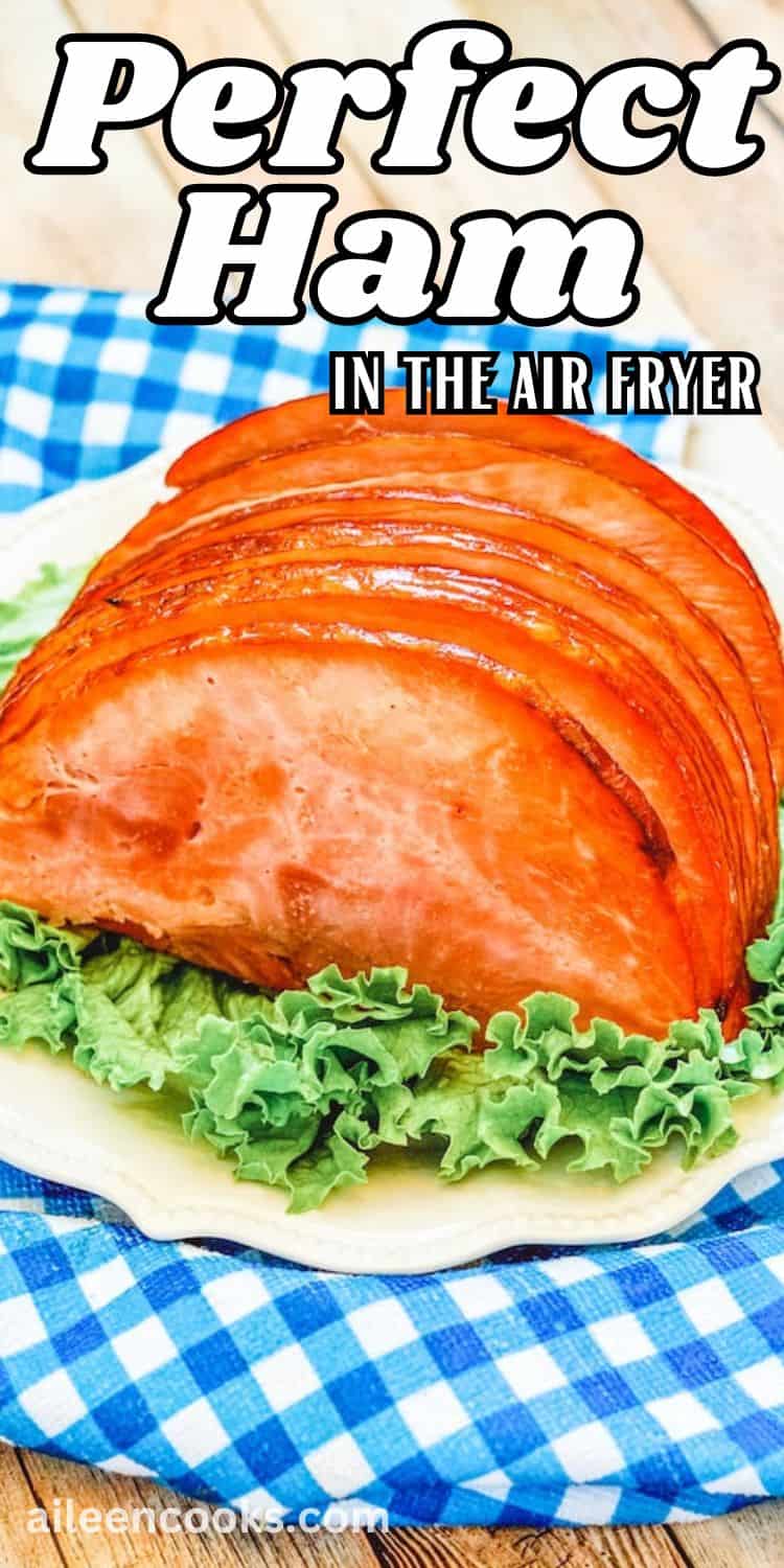 A white platter filled with thin sliced ham.
