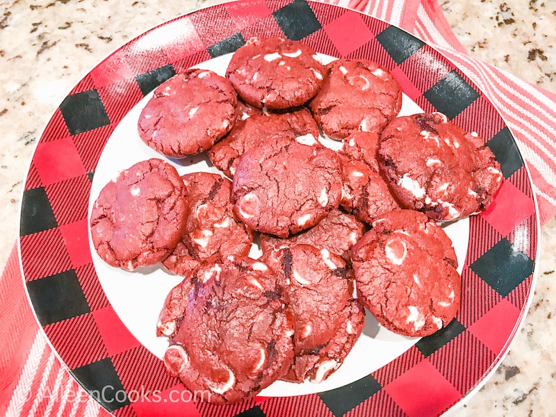 A buffalo plaid plate filled with red velvet cookies.
