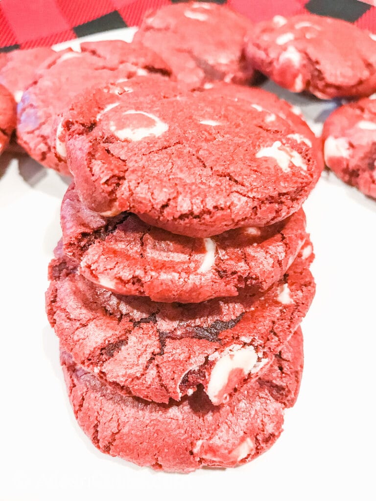 A stack of red velvet cookies on a white plate.