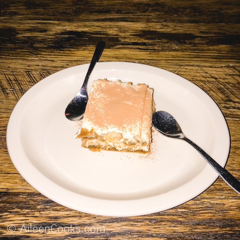 A plate of dessert with two spoons.