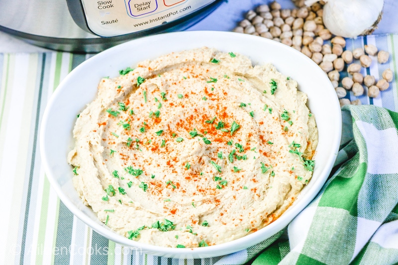 Bowl of hummus in a front of instant pot.