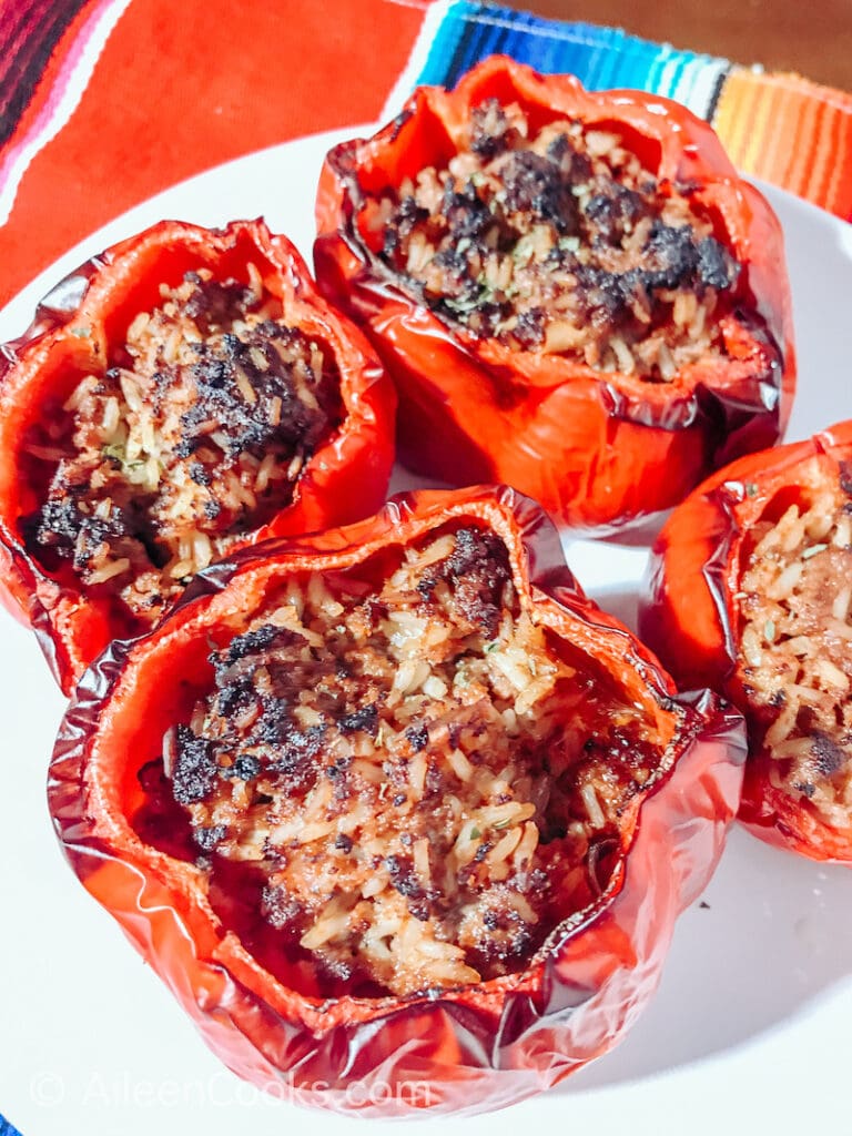 Air fryed stuffed bell peppers on a white plate.