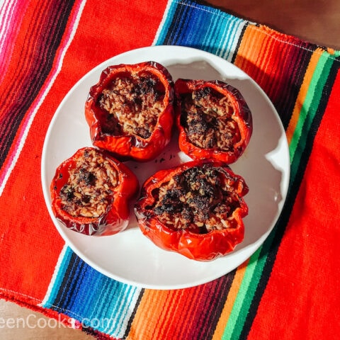 Stuffed peppers arranged on a white plate.