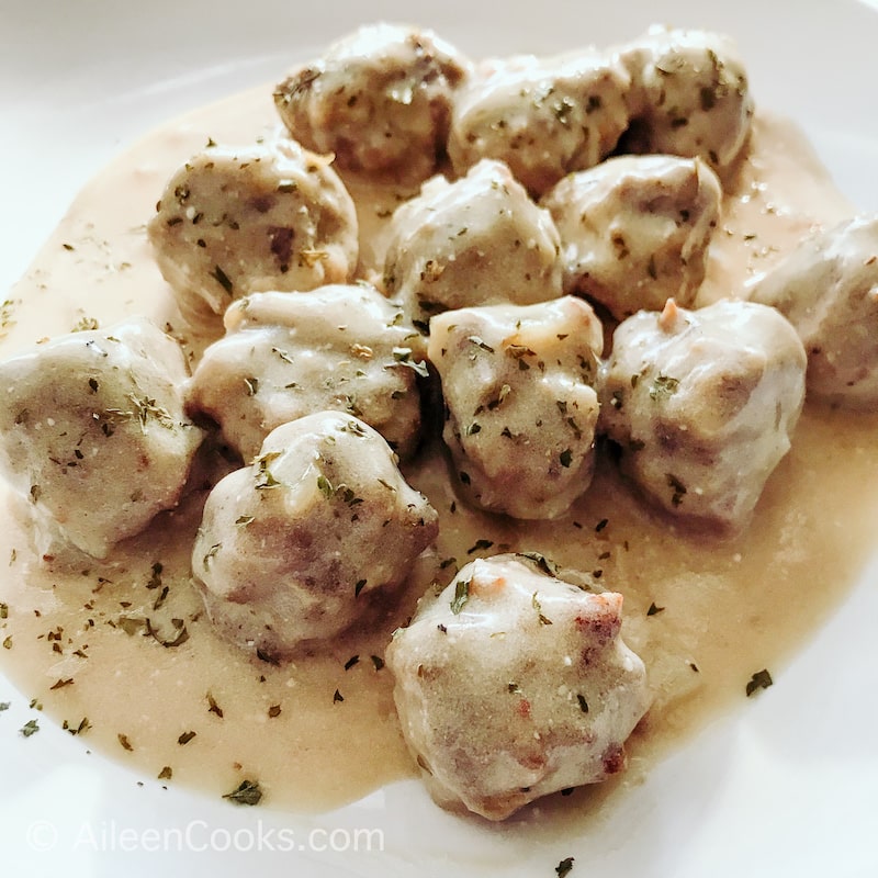 Close up of meatballs coated in a Swedish meatball gravy.