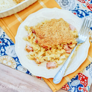 A plate of chicken cordon bleu casserole on a blue and yellow placemat.