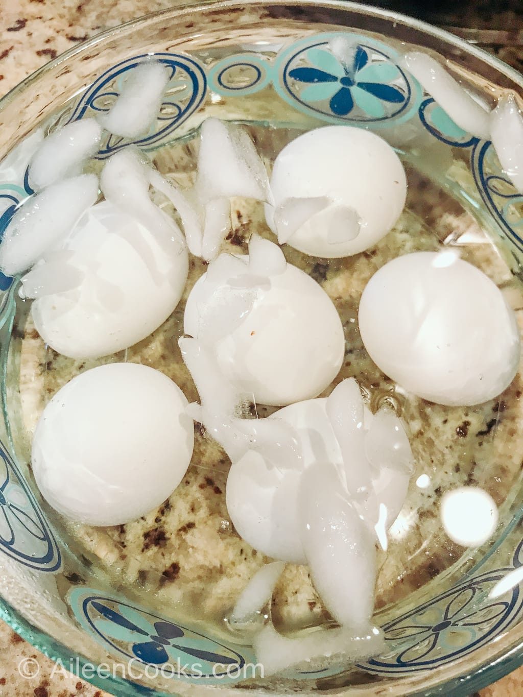 Eggs inside ice water with ice melted.