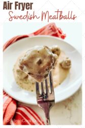 A Swedish meatball on the end of a fork with the words "air fryer Swedish meatballs" in red and brown lettering.