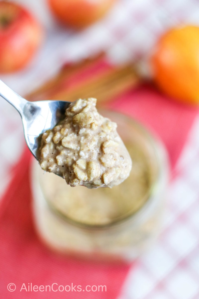 A spoonful of overnight oats held over the jar of oats.