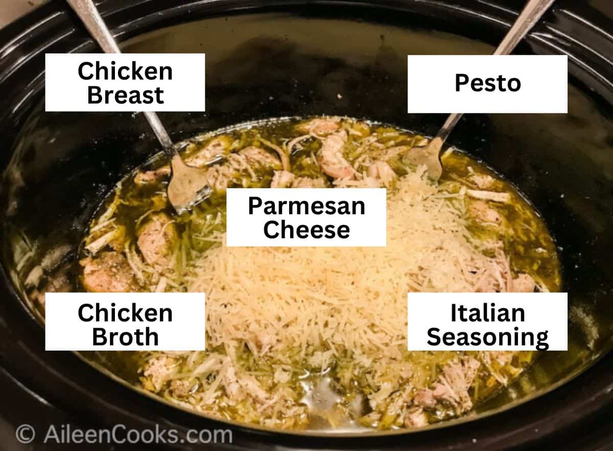 Pesto chicken inside slow cooker pot.