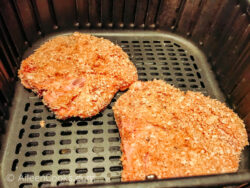 Breaded pork chops inside air fryer.