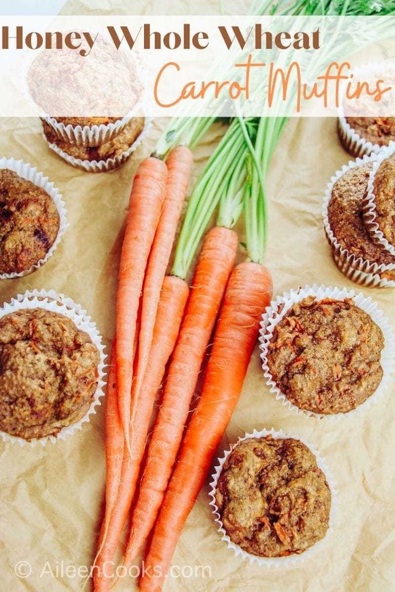 Carrot muffins surrounding a bunch of carrots with the words "honey whole wheat carrot muffins" in brown and orange lettering.