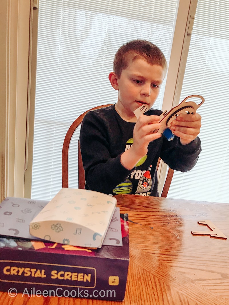 A boy building a crystal screen from Mel Kids box.