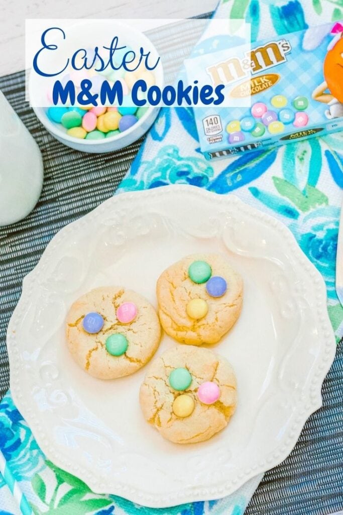 A white plate with three Easter cookies on it and the words "Easter M&M Cookies" In blue lettering.