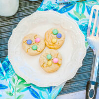 A blue placemat topped with a plate of Easter themed cookies.