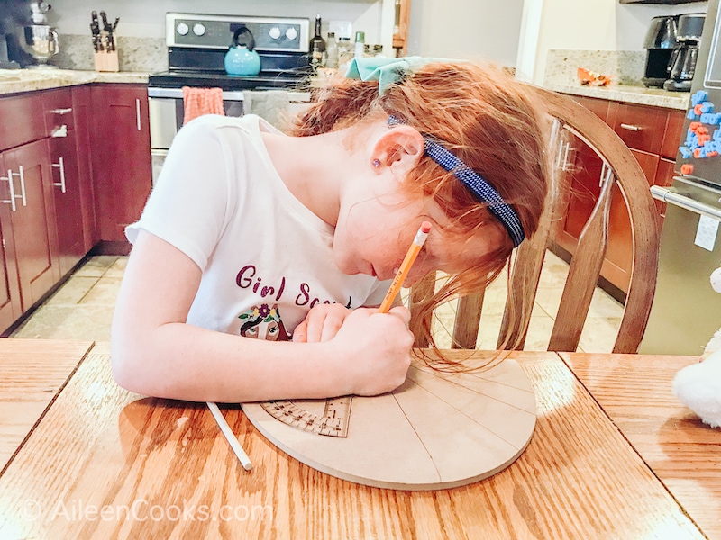 A girl designing a sundial.