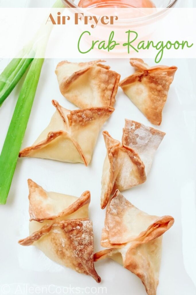 Fried wontons on a plate with the words "air fryer crab rangoon" in brown and green lettering.