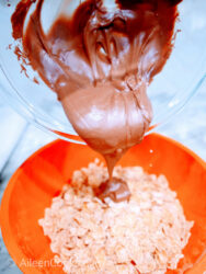 Chocolate being poured over a bowl of Frosted Flakes.