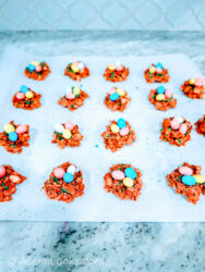 Birds nest cookies arranged on a parchment lined baking sheet.