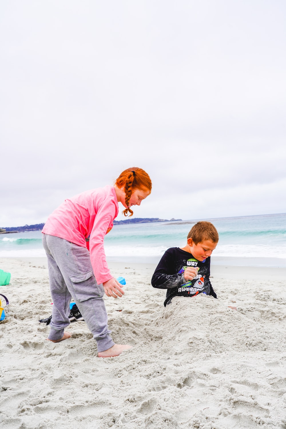 A boy and girl playing in the sand at Carmel Beach