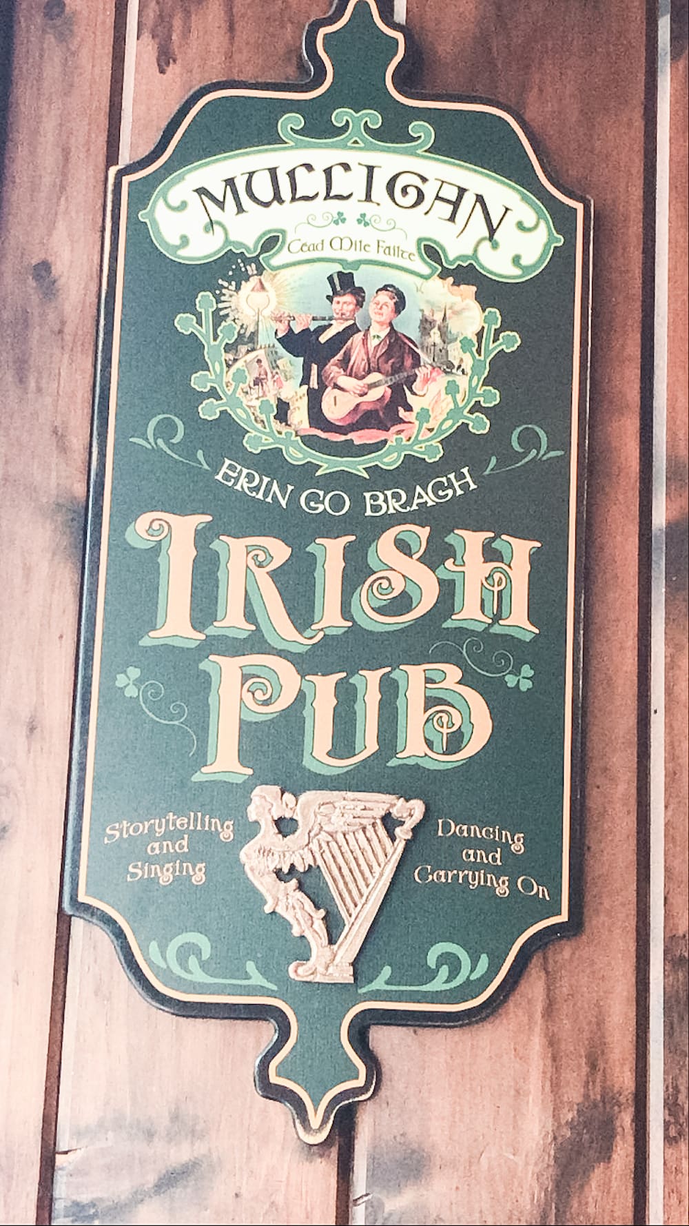 A wooden sign that says "Mulligan's Irish Pub".