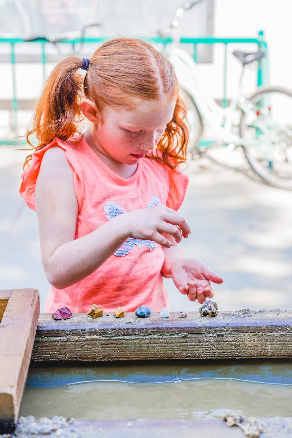 A girl lining up the gems she mined at Tower Park in Lodi, CA.