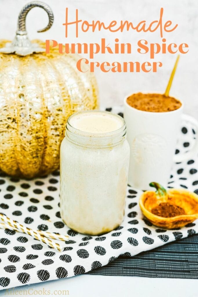 A glass jar full of pumpkin spice coffee creamer with the words "homemade pumpkin spice creamer" in orange lettering.