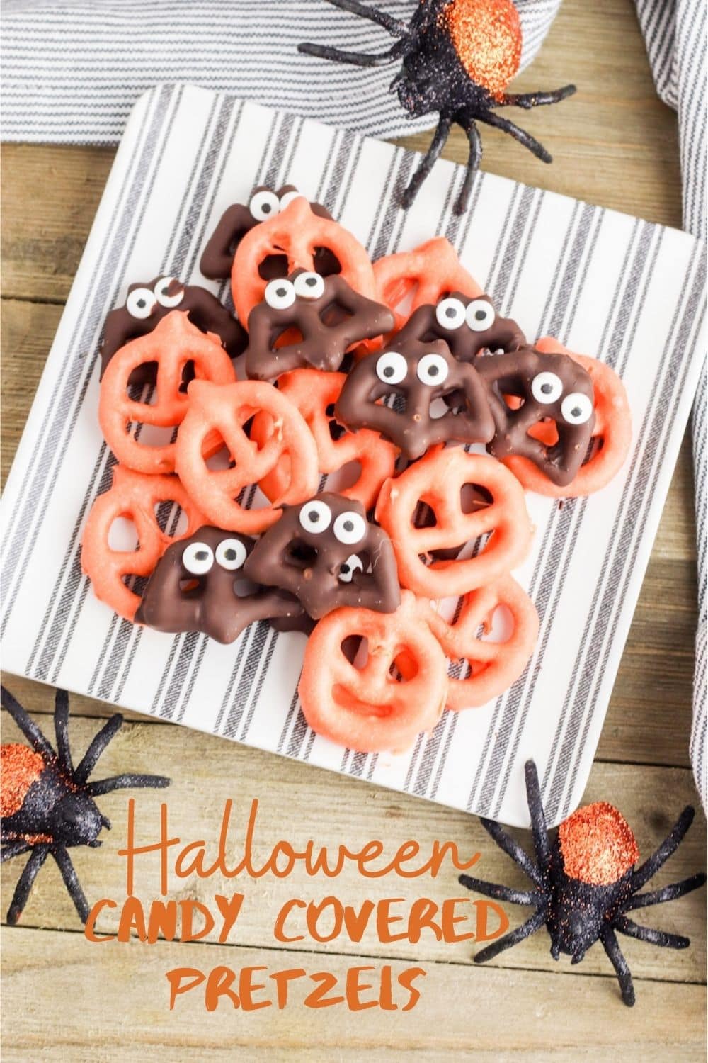 A plate of candy covered pretzels decorated for halloween.