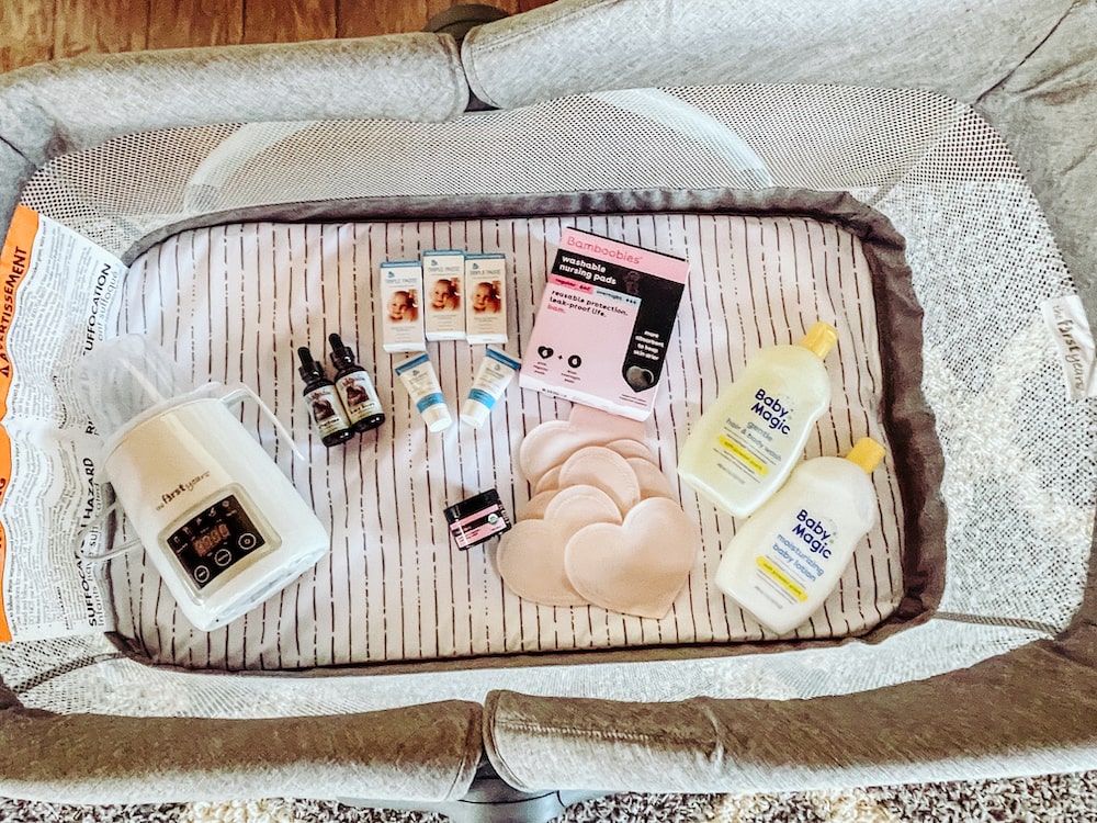 A bassinet filled with gift ideas for a new mom and baby.