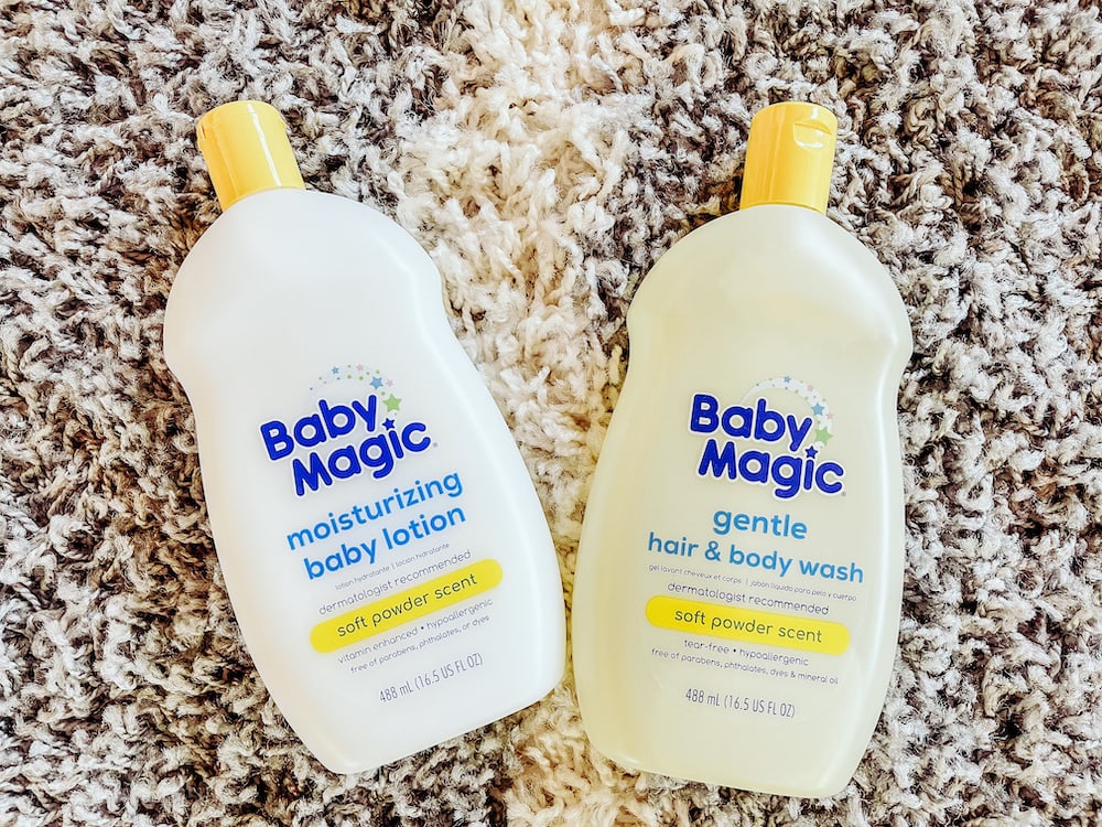 Two bottles of baby magic on a grey rug.