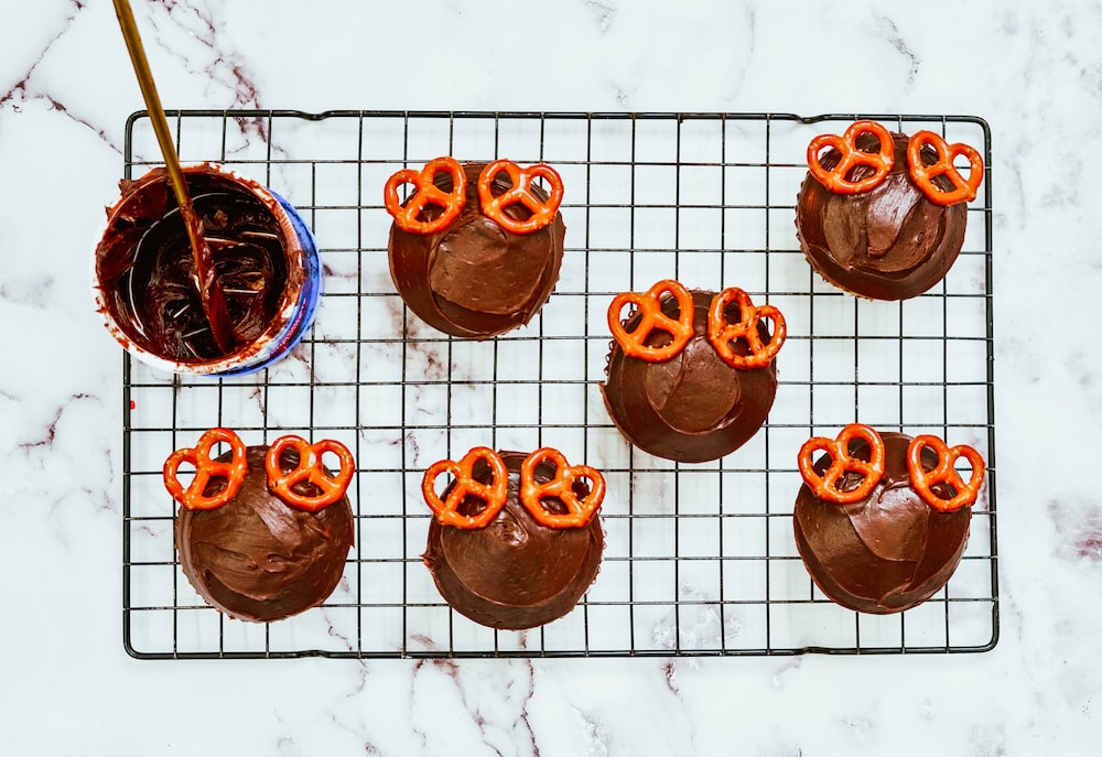 Chocolate cupcakes with two mini pretzels for antlers.