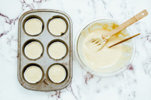 Muffin tin filled with cupcake batter.