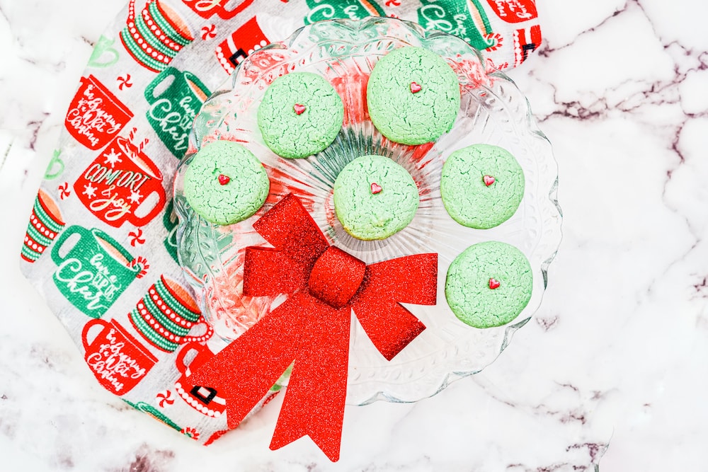 A tray filled with green sugar cookies.