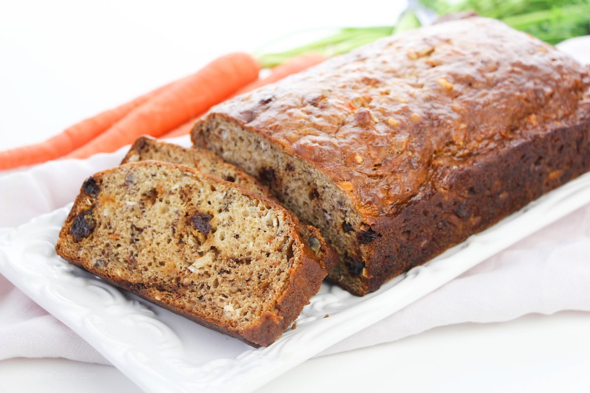 A loaf of carrot bread on a white platter.