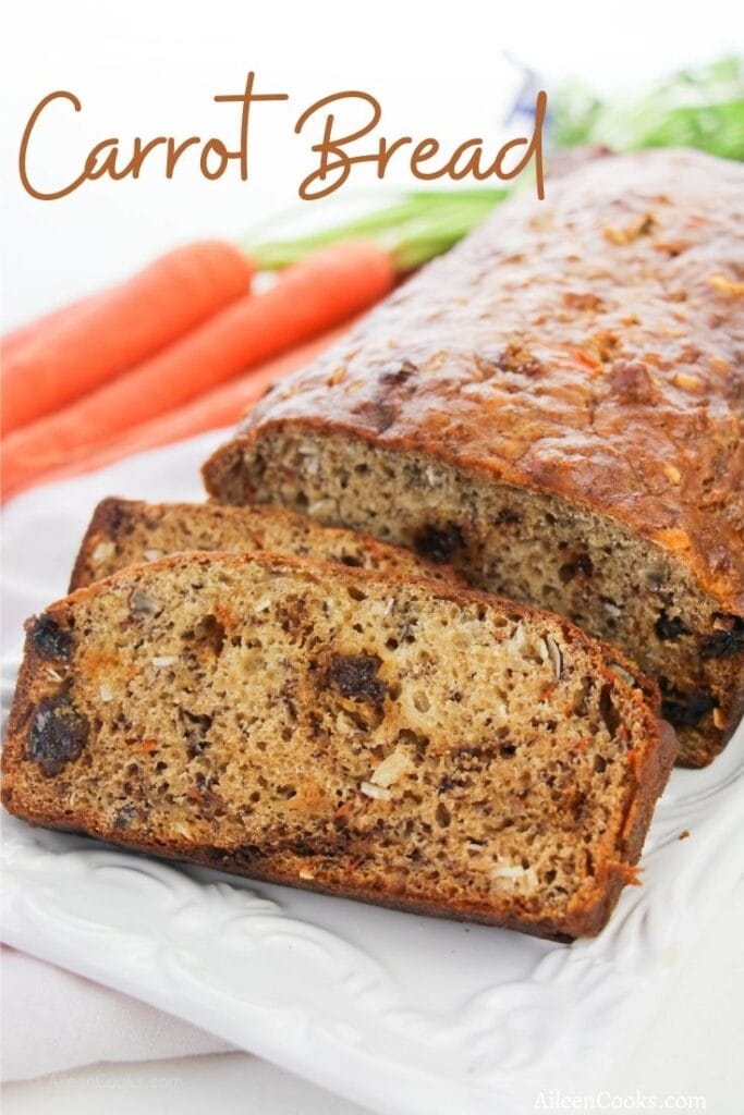 A loaf of carrot bread with the words "Carrot Bread" in brown script lettering.