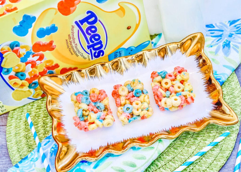 A box of Peeps Cereal next to a dish with three cereal bars.