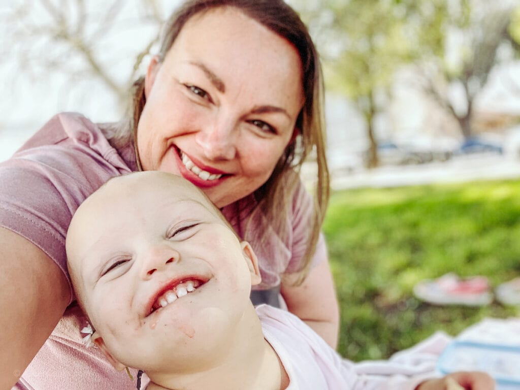 A mom and baby taking a selfie and laughing.