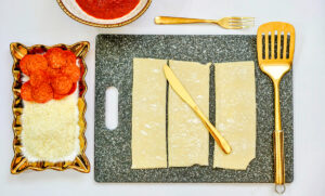 A sheet of puff pastry cut into three slices.