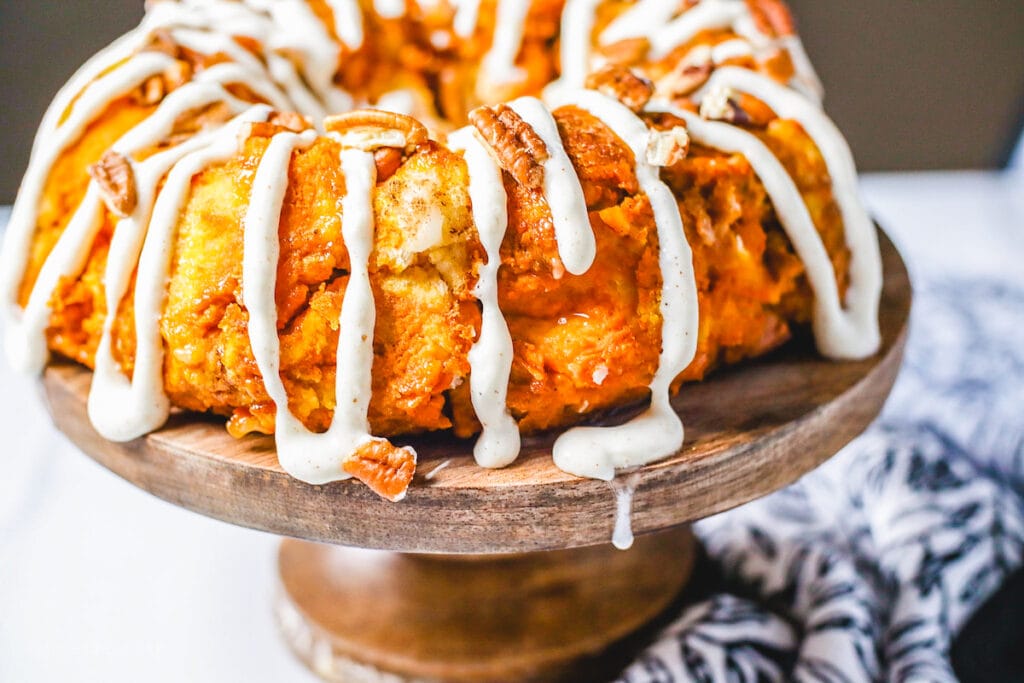 Close up picture of pumpkin monkey bread on top of a cake stand.
