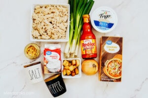 Ingredients laid out on a marble counter top to make Buffalo Chicken Soup