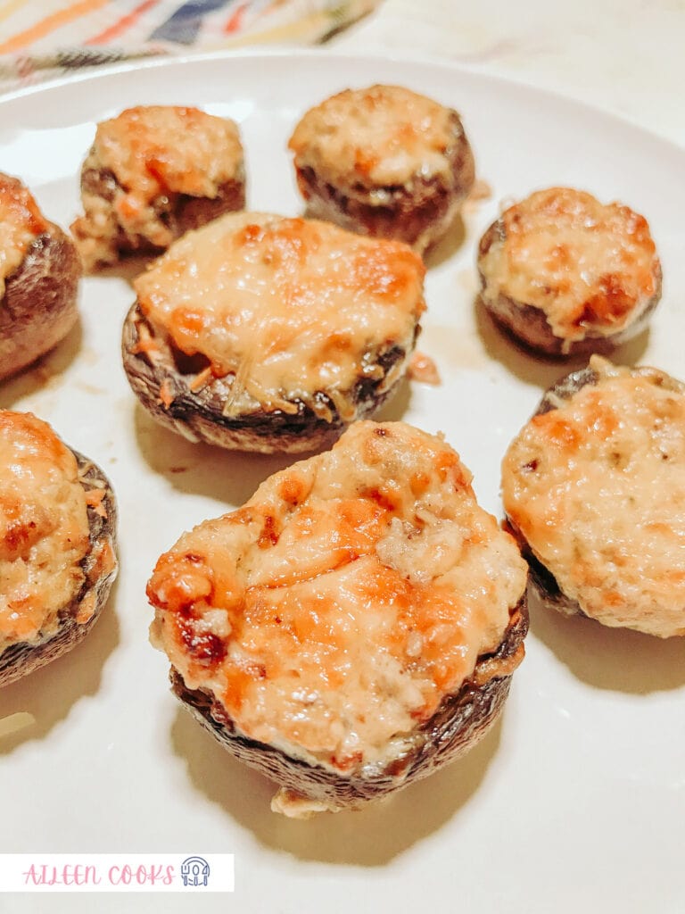 Close-up photo of stuffed mushrooms, cooked from the air fryer, served on a white plate