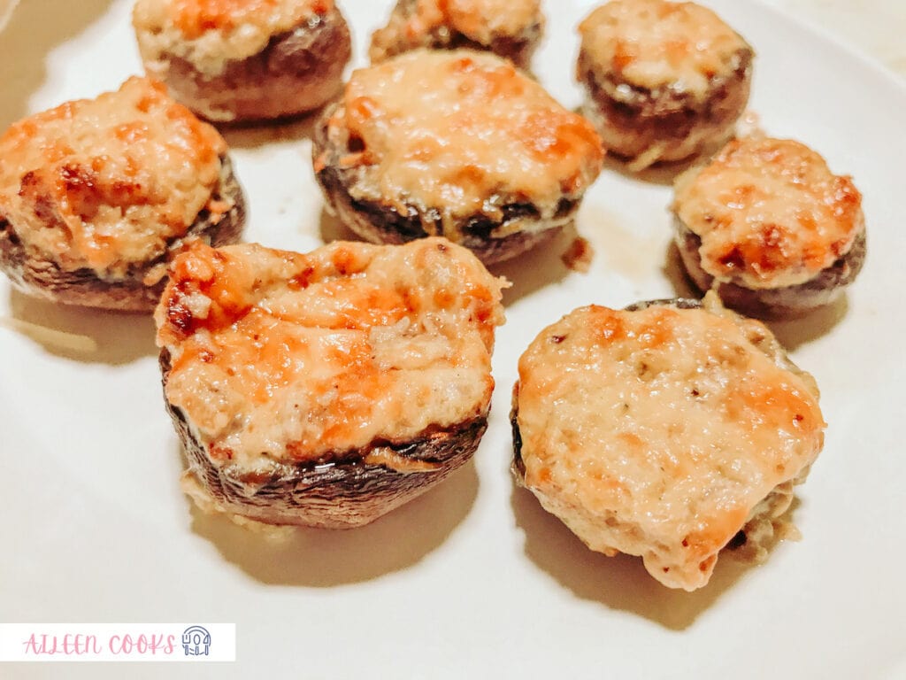 Close-up photo of stuffed mushrooms, cooked from the air fryer, served on a white plate