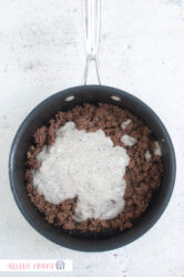 Ground beef and cream of mushroom being browned in a non-stick skillet