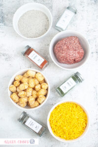Ingredients to make an air fryer tater tot casserole, laid out on a grey background