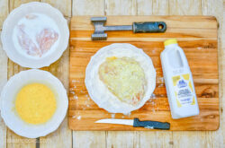 Ingredients required to make a homemade Crispy Chicken Sandwich recipe – including chicken, a plate of eggs, buttermilk, and flour