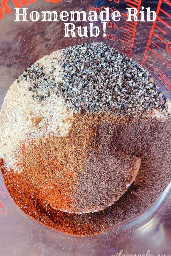 Close up picture of the spices needed for a rib rub inside a glass container.