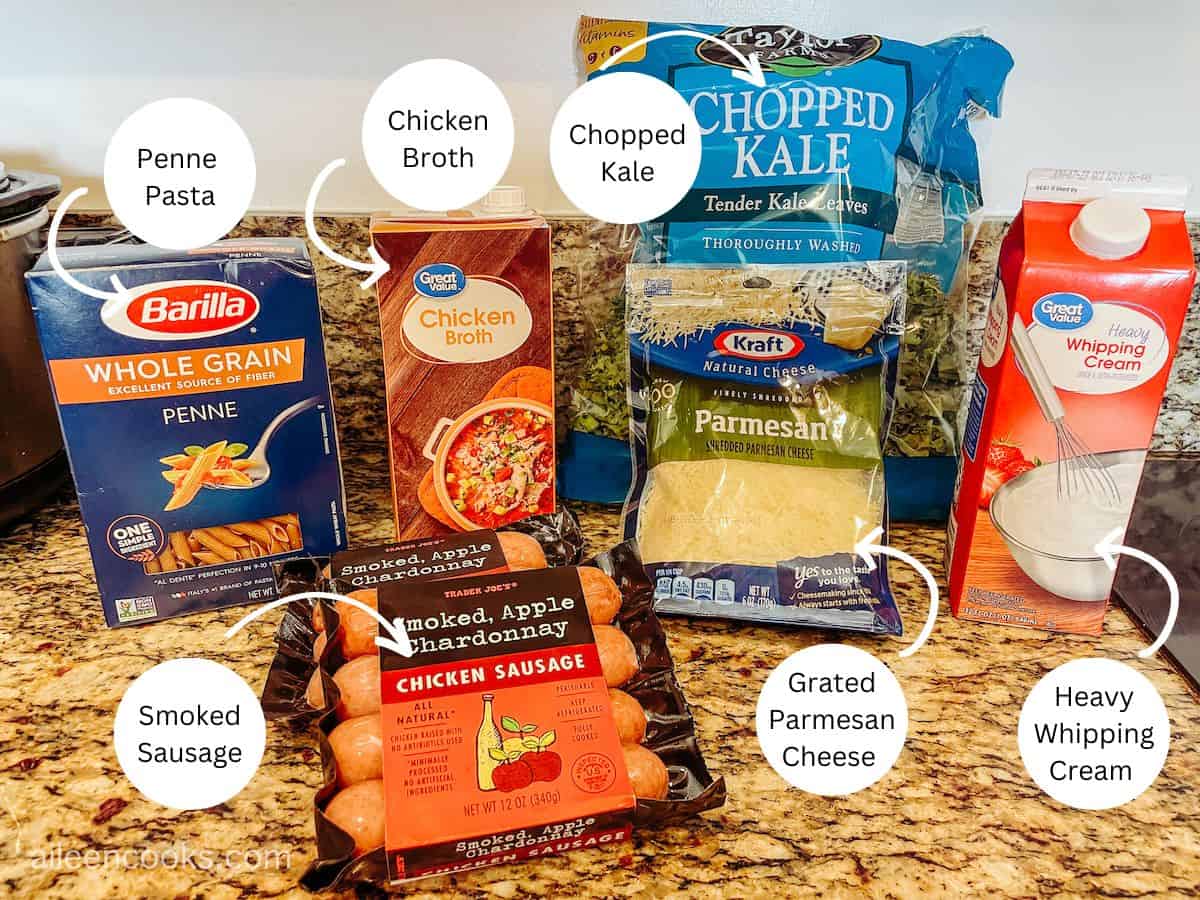 All of the ingredients for one pot sausage kale pasta laid out on a counter, with labels on each photo.